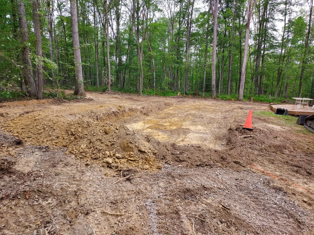 A lot cleared and rough-graded with the pad corner marked