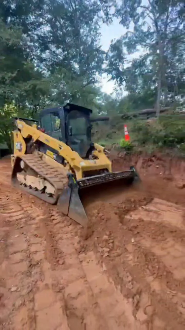 Our skid steer cutting grade across red clay